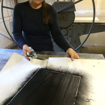 Elvia Perrin using a deep black to make a painting.