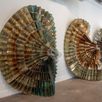 exhibition view of three skirts made from sheet metal by Naomi Wanjiku Gakunga