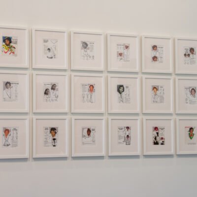 A wall of 18 digital collage prints in white frames. Titled Daisy's Casual Corner by Lauren Cross