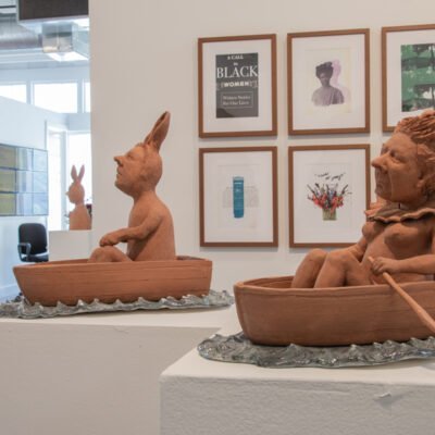terra-cotta and earthenware of two figures, each in their own row boat. Titled Nervous Waters by Pat Johnson