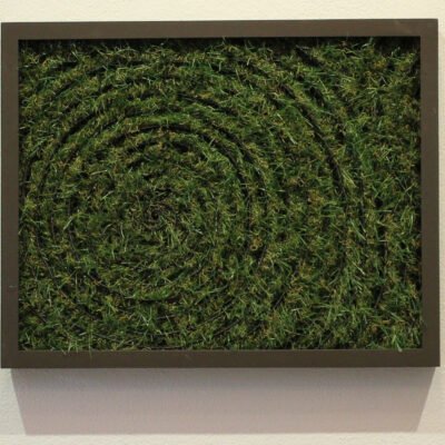 a frame with a spiral of artificial grass inside