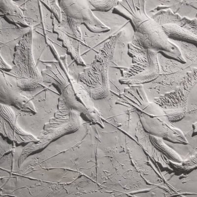 relief sculpture of birds in flight, maybe seagulls
