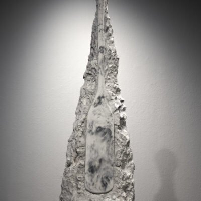 another sculpture of a paddle. there is barnacles corroded at the bottom