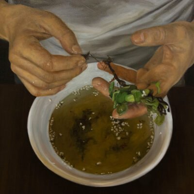detail of hands holding wet venus flytrap