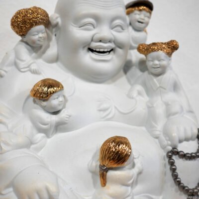 porcelain featuring gold luster of a chubby, grinning man with tiny children sitting on his shoulders.