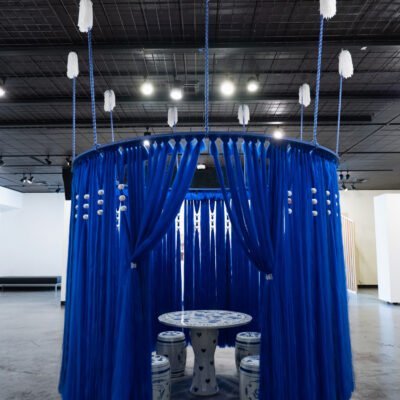 Porcelain table inside of the blue hanging installation.
