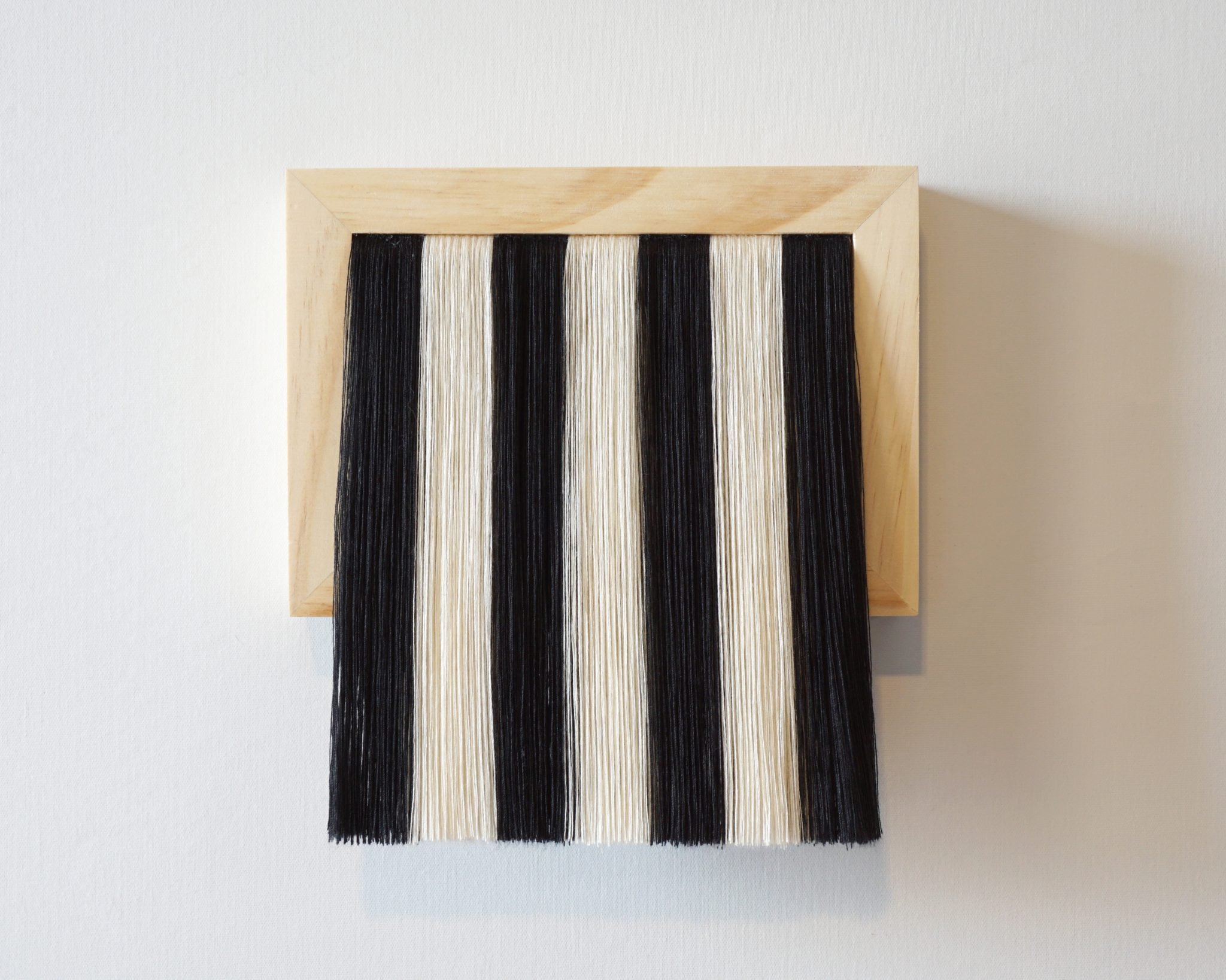 Bumin Kim, "Vexillum No. 24"; thread and wood; 7" x 7.5"