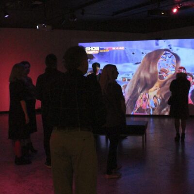 People viewing a digital video in the gallery.